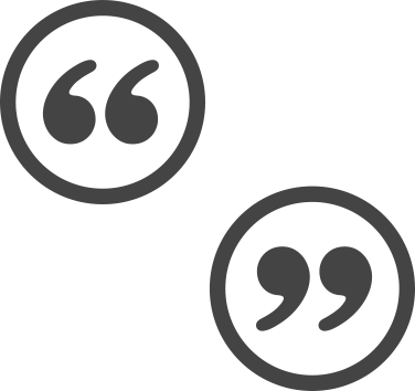 Grey quotation marks in grey circles positioned diagonally from each other.