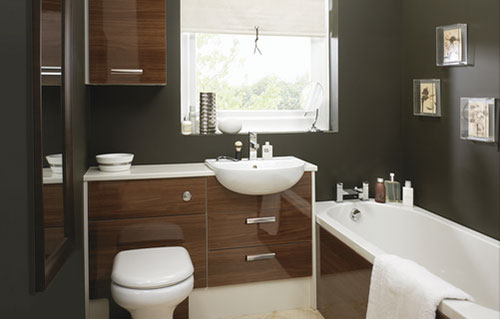 A glossy brown bathroom with pictures on the wall.